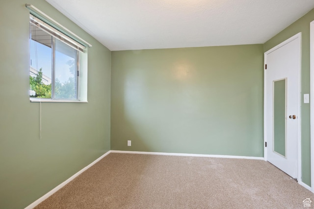 carpeted spare room with baseboards