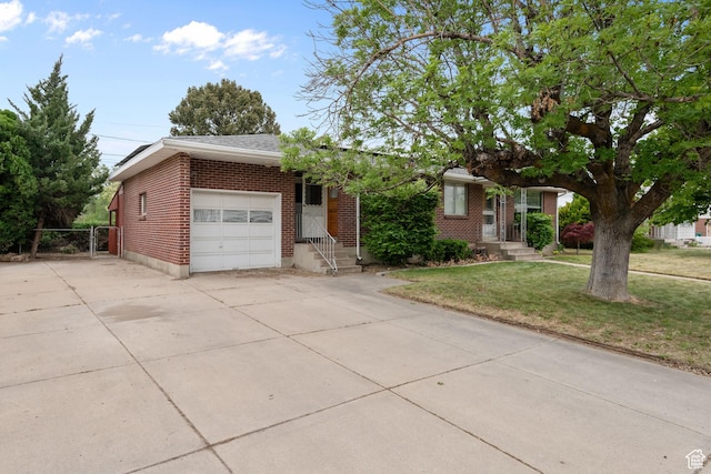 view of front of house featuring brick siding, an attached garage, driveway, a front lawn, and entry steps