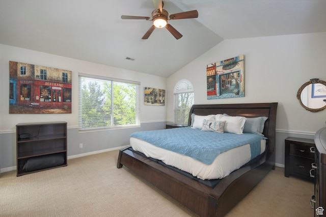carpeted bedroom featuring vaulted ceiling, baseboards, and a ceiling fan