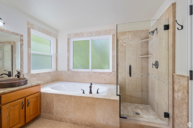 full bath with a stall shower, a bath, vanity, and tile patterned floors