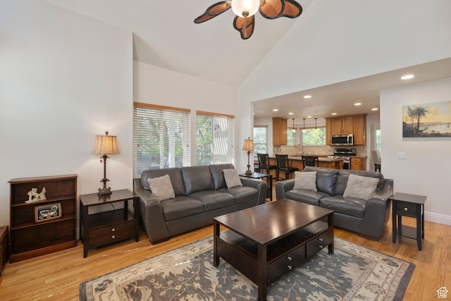 living room with a ceiling fan, light wood finished floors, high vaulted ceiling, recessed lighting, and baseboards