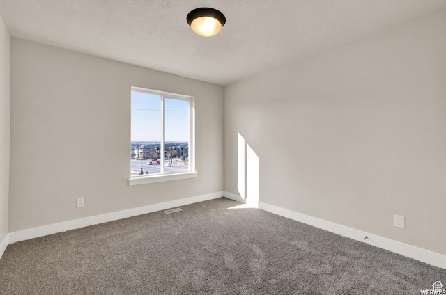 carpeted spare room with baseboards