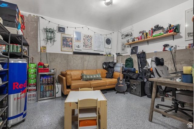 game room featuring speckled floor and a desk