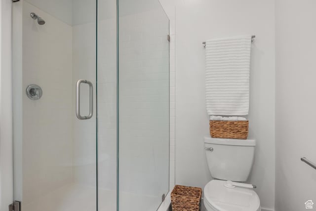 full bath with a shower stall, toilet, and baseboards