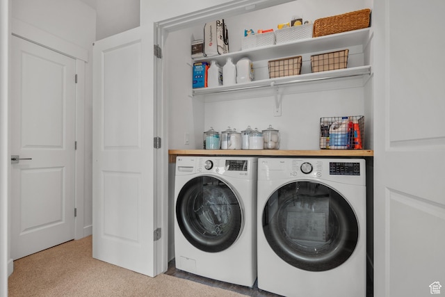 laundry area with washing machine and dryer and light colored carpet
