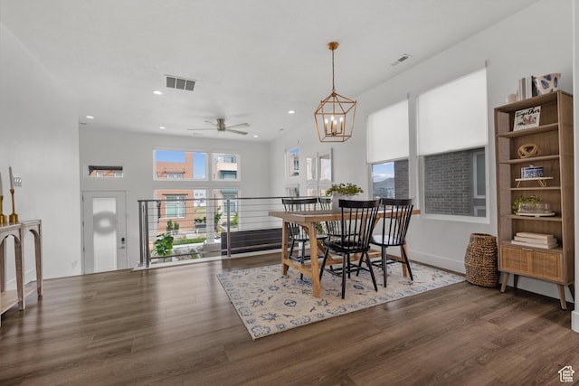 dining space with wood finished floors, ceiling fan, a chandelier, and recessed lighting