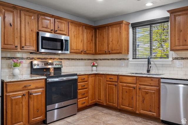 1066 W 1325 S, Springville, UT 84663 - kitchen with stainless steel appliances, a sink, brown cabinetry, backsplash, and recessed lighting
