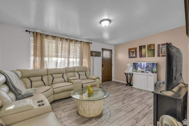living area with light wood-type flooring and baseboards