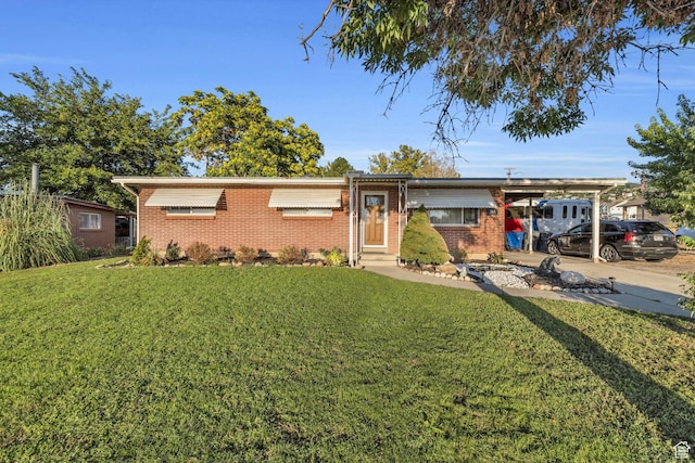 single story home with a front yard, brick siding, and a carport