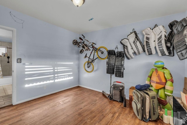 miscellaneous room with wood finished floors and baseboards
