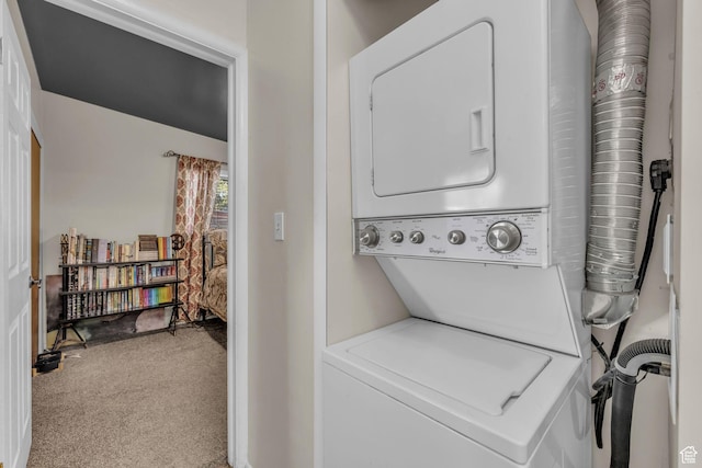 laundry area with stacked washing machine and dryer and carpet flooring