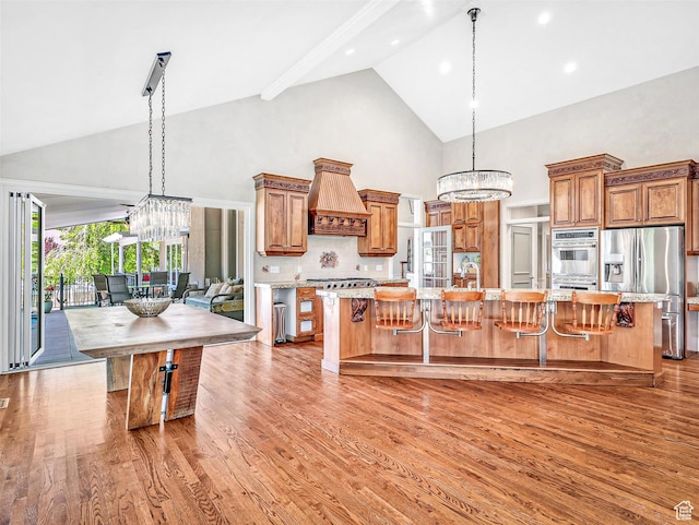 10868 S Prescott Dr E, Sandy, UT 84092 - kitchen with appliances with stainless steel finishes, a chandelier, high vaulted ceiling, light wood-style flooring, and recessed lighting