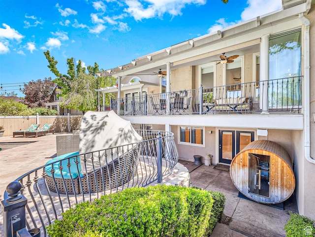10868 S Prescott Dr E, Sandy, UT 84092 - back of house featuring a ceiling fan, fence, a balcony, stucco siding, and a patio area