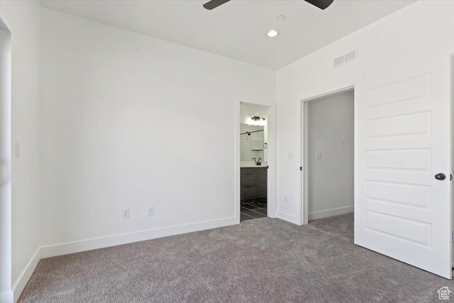 unfurnished bedroom with carpet flooring, baseboards, ensuite bath, and recessed lighting
