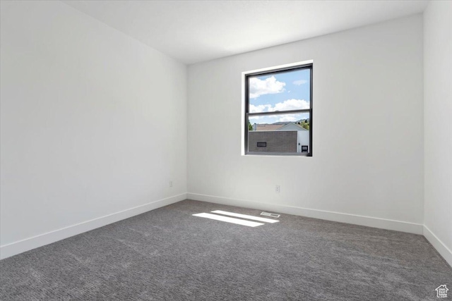 spare room with carpet flooring and baseboards