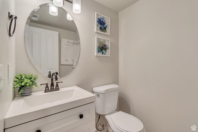 bathroom featuring toilet and vanity