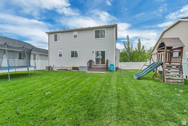 back of property featuring a trampoline, a playground, central AC, and entry steps