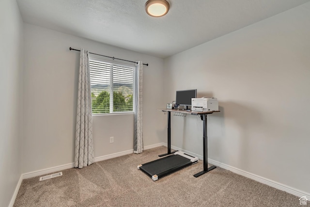 exercise room featuring carpet floors and baseboards