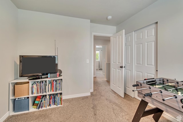 recreation room with carpet floors and baseboards
