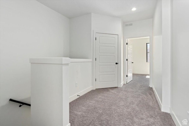 corridor featuring carpet flooring, baseboards, and recessed lighting