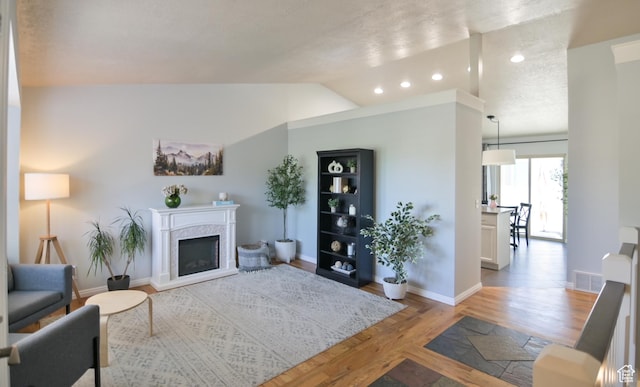 4931 W Berry Creek Dr, Riverton, UT 84096 - living room featuring a premium fireplace, light wood-style flooring, baseboards, vaulted ceiling, and recessed lighting