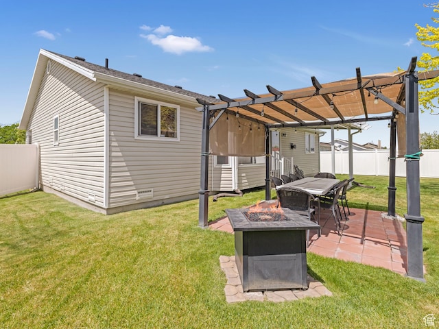 back of property with a fire pit, a pergola, and a patio area