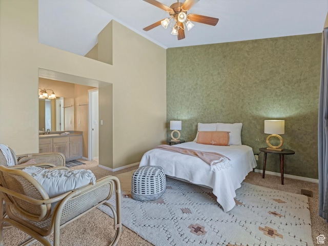 carpeted bedroom with a chandelier, baseboards, a sink, ensuite bath, and a towering ceiling
