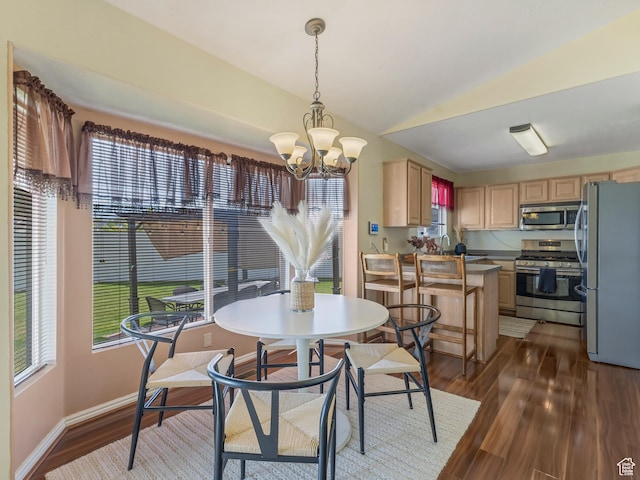dining space featuring a chandelier, dark wood-style flooring, vaulted ceiling, and baseboards