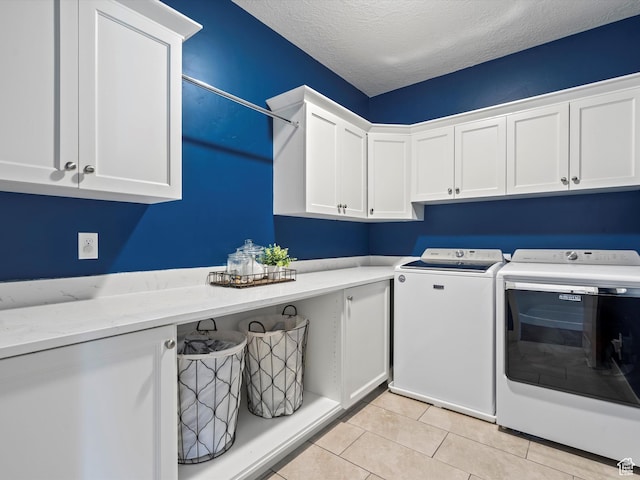 4591 N Abbey Way, Eden, UT 84310 - washroom featuring cabinet space, washing machine and clothes dryer, light tile patterned floors, and a textured ceiling