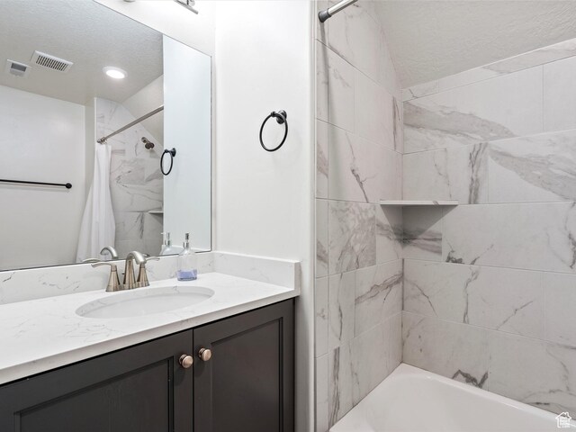 4591 N Abbey Way, Eden, UT 84310 - bathroom featuring a textured ceiling, vanity, and shower / bath combo with shower curtain