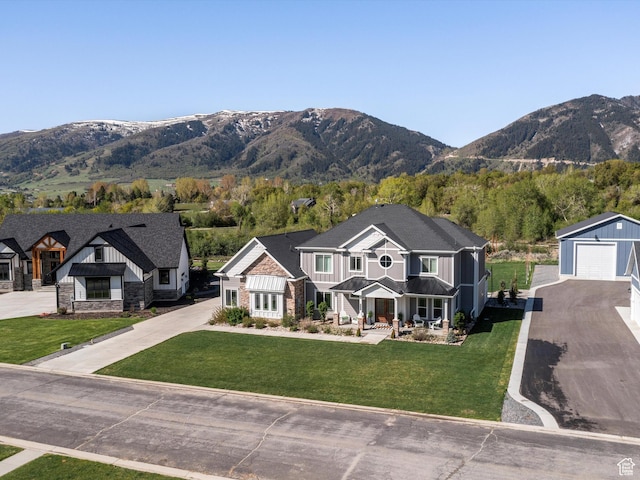 4591 N Abbey Way, Eden, UT 84310 - view of front of property with a mountain view, a detached garage, driveway, a front lawn, and a porch