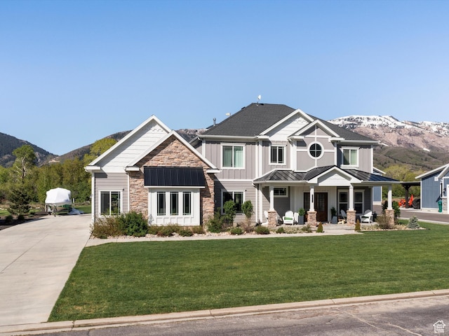 4591 N Abbey Way, Eden, UT 84310 - craftsman inspired home with a standing seam roof, a mountain view, stone siding, and a porch