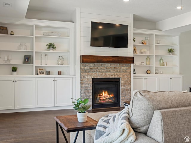 4591 N Abbey Way, Eden, UT 84310 - living room with dark wood-type flooring, a fireplace, and built in features