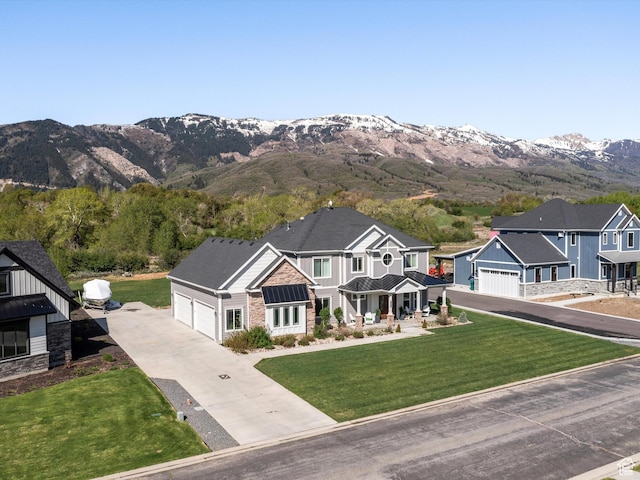 4591 N Abbey Way, Eden, UT 84310 - craftsman-style home with stone siding, concrete driveway, a mountain view, a standing seam roof, and a front lawn