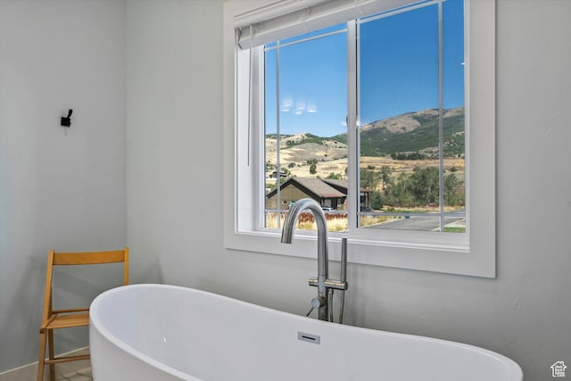 4591 N Abbey Way, Eden, UT 84310 - bathroom view of a sink, a freestanding bath, a mountain view, and baseboards