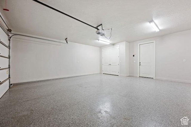 3837 W Lazy River Cir Unit 100, Santa Clara, UT 84765 - garage with baseboards and a garage door opener
