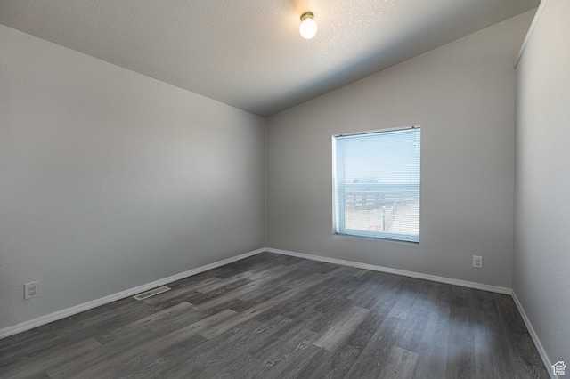 1074 Altus Ln, Fredonia, AZ 86022 - empty room featuring vaulted ceiling, dark wood-style floors, and baseboards