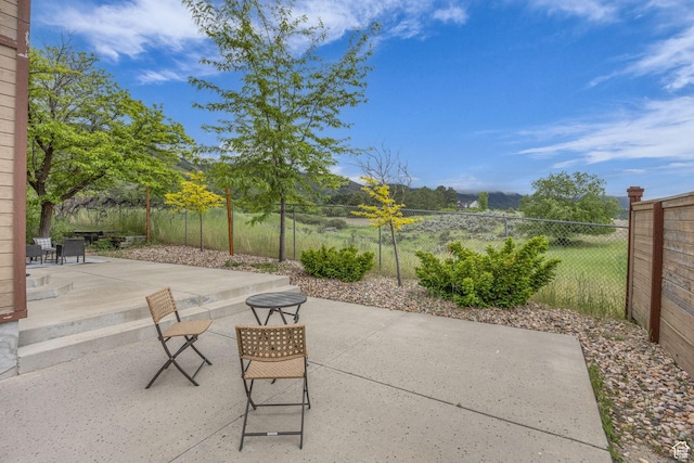 3270 E Danish Hills Cir, Salt Lake City, UT 84121 - view of patio with fence and a mountain view