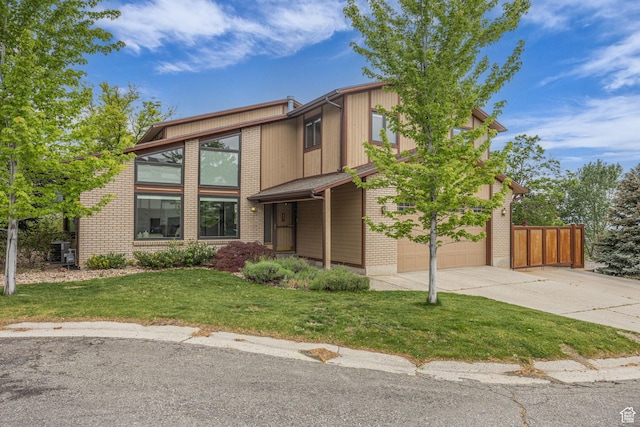 3270 E Danish Hills Cir, Salt Lake City, UT 84121 - view of front of home with driveway, a garage, central AC unit, and brick siding