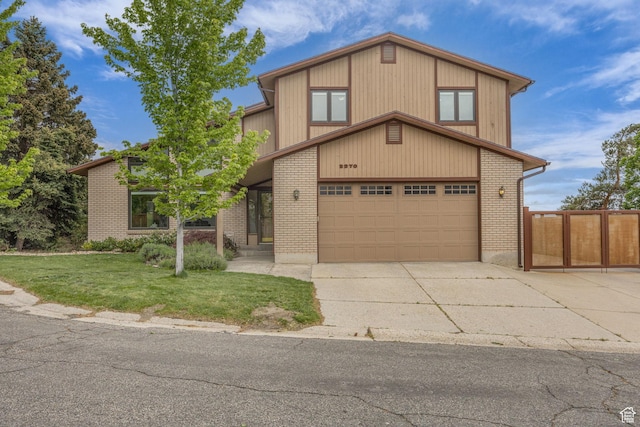 3270 E Danish Hills Cir, Salt Lake City, UT 84121 - view of front of house with concrete driveway, brick siding, and an attached garage