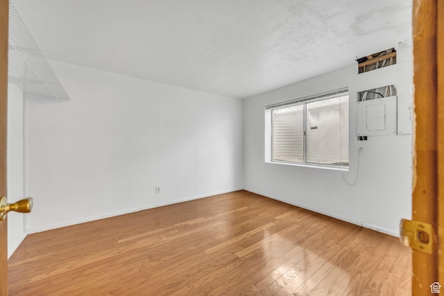 3270 E Danish Hills Cir, Salt Lake City, UT 84121 - empty room with wood finished floors, baseboards, and electric panel
