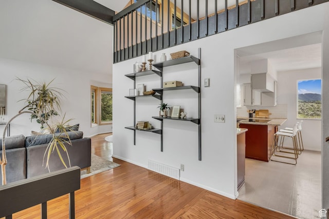 3270 E Danish Hills Cir, Salt Lake City, UT 84121 - interior space featuring a high ceiling, light wood-type flooring, baseboards, and stairs