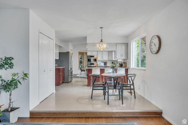 3270 E Danish Hills Cir, Salt Lake City, UT 84121 - dining room featuring baseboards and a chandelier