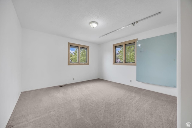 3270 E Danish Hills Cir, Salt Lake City, UT 84121 - spare room featuring carpet floors and a textured ceiling