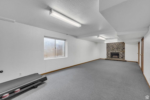 3270 E Danish Hills Cir, Salt Lake City, UT 84121 - basement with a fireplace, baseboards, a textured ceiling, and carpet floors