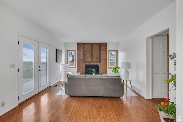 3270 E Danish Hills Cir, Salt Lake City, UT 84121 - living area featuring light wood finished floors, a fireplace, and baseboards