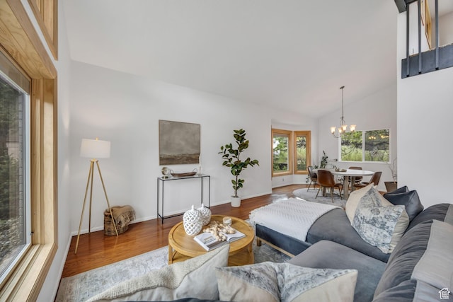 3270 E Danish Hills Cir, Salt Lake City, UT 84121 - living room featuring a chandelier, wood finished floors, vaulted ceiling, and baseboards