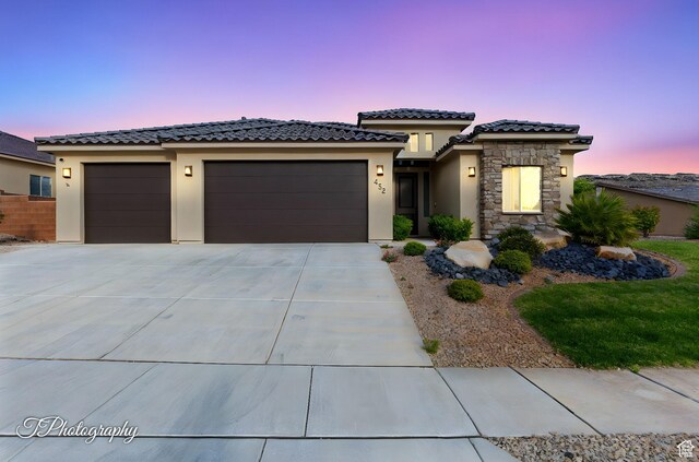 452 N Sage Grouse Dr, Washington, UT 84780 - prairie-style house with a garage, stucco siding, concrete driveway, a tile roof, and stone siding