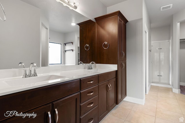 452 N Sage Grouse Dr, Washington, UT 84780 - full bathroom with tile patterned floors, double vanity, a shower stall, and baseboards
