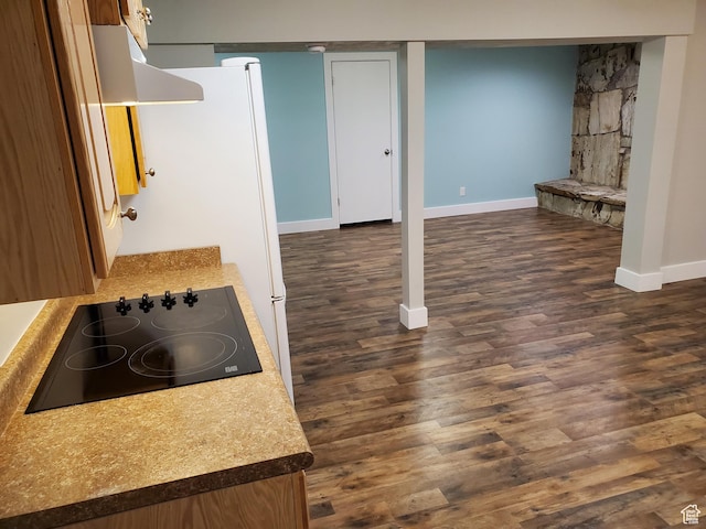 finished basement featuring baseboards and dark wood finished floors